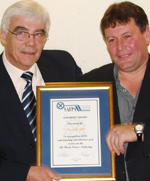 Fritz Kern presenting Russell Gill with the 2006 Merit Award